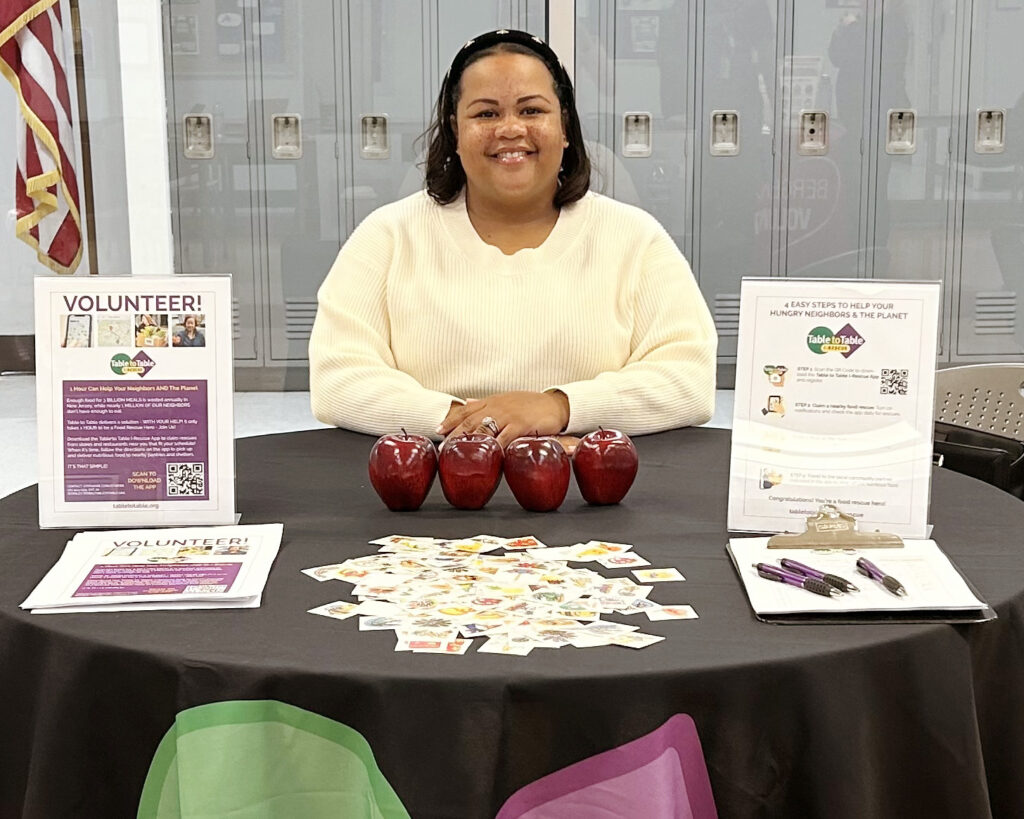 Table to Table's Stephanie Conley-Webb  

hosting a table at a community service fair 

 